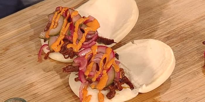 BBQ brisket bao buns with cucumber and red onion pickle