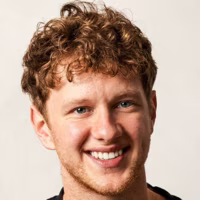 A headshot of plant-based food creator Calum Harris smiling warmly