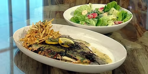 Butterflied-sea-bass-with-shoestring-fries-and-salad.avif